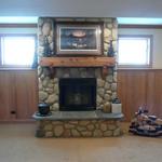 Fireplace with stone veneer, rustic cedar mantle and blue stone hearth 